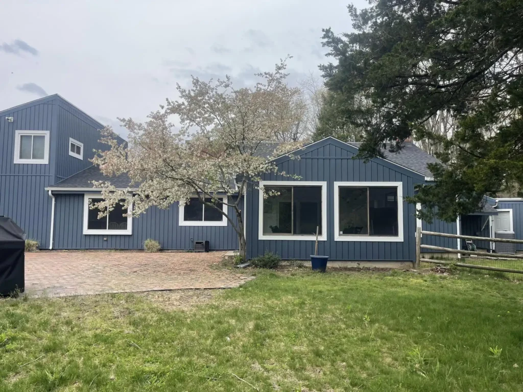 A house with all new blue siding and windows.