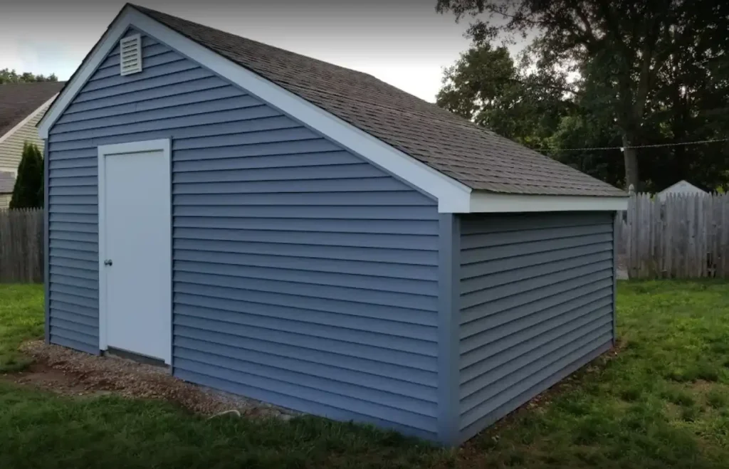 A shed with blue siding.